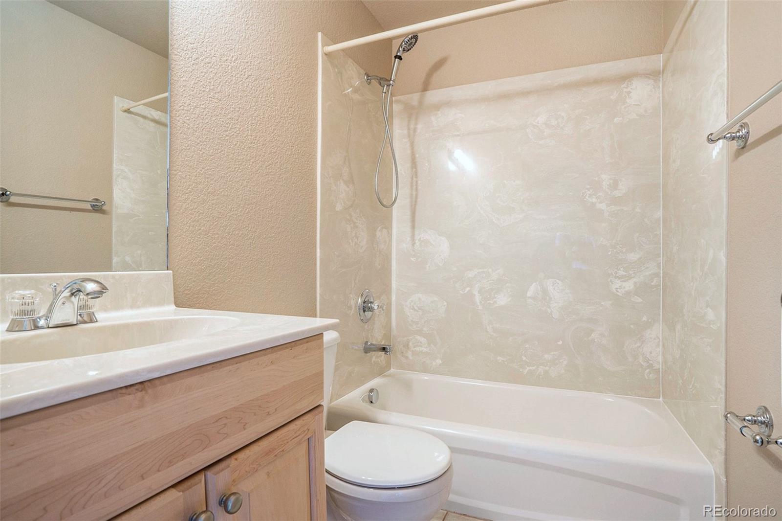 1131 Westmoreland Road Colorado Springs, CO 80907 - Photo 22 of 30 a bathroom with a sink a toilet and a bathtub