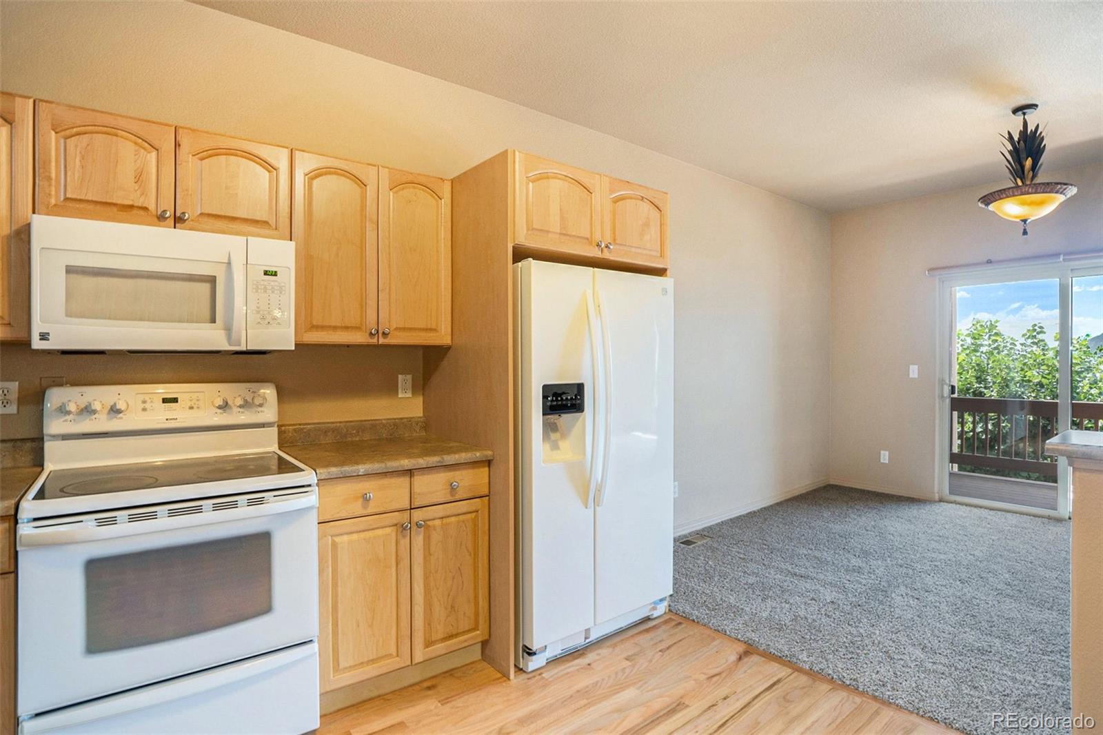 1131 Westmoreland Road Colorado Springs, CO 80907 - Photo 8 of 30 a kitchen with stainless steel appliances white cabinets and a stove top oven