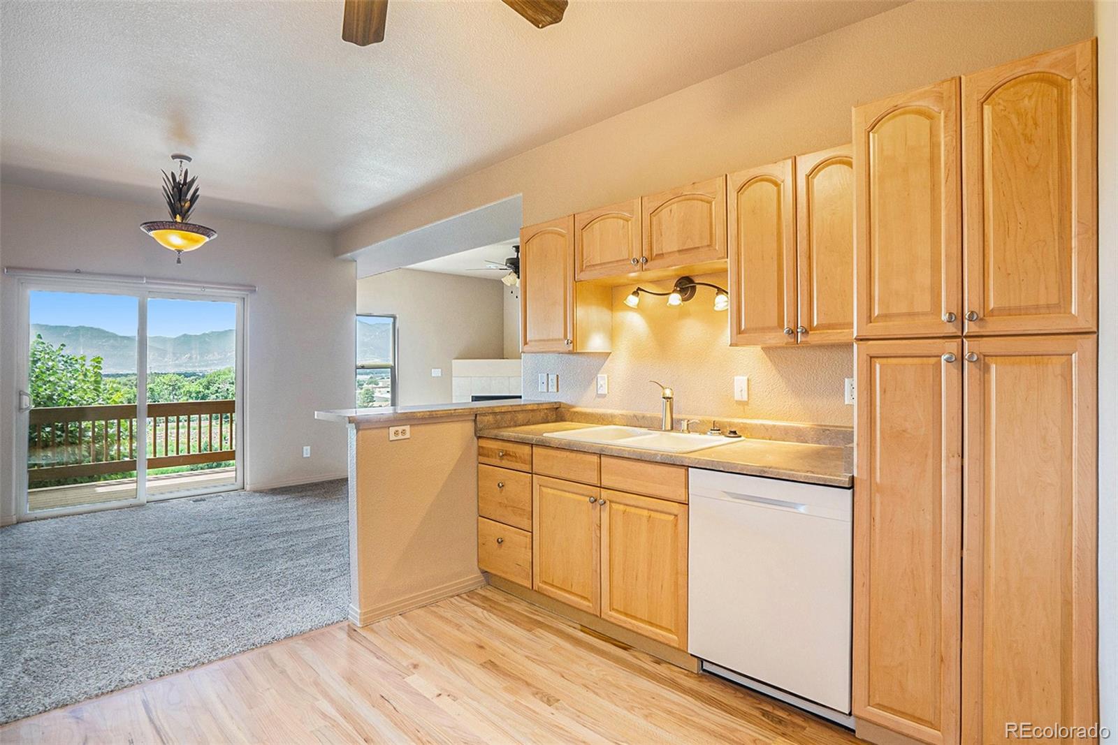 1131 Westmoreland Road Colorado Springs, CO 80907 - Photo 9 of 30 a bathroom with a granite countertop sink and a mirror