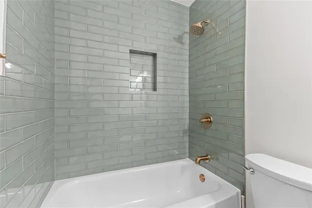 a bathroom with a bathtub and a toilet