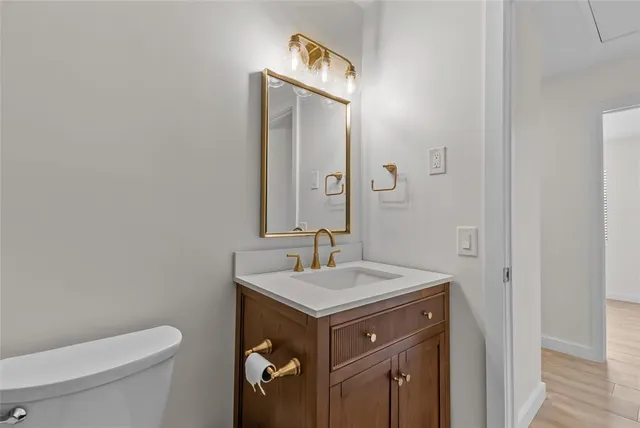 a bathroom with a sink toilet and mirror