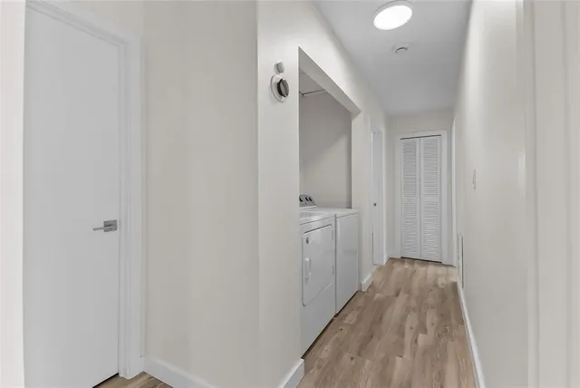a view of a hallway with wooden floor
