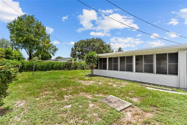 a view of a house with a backyard