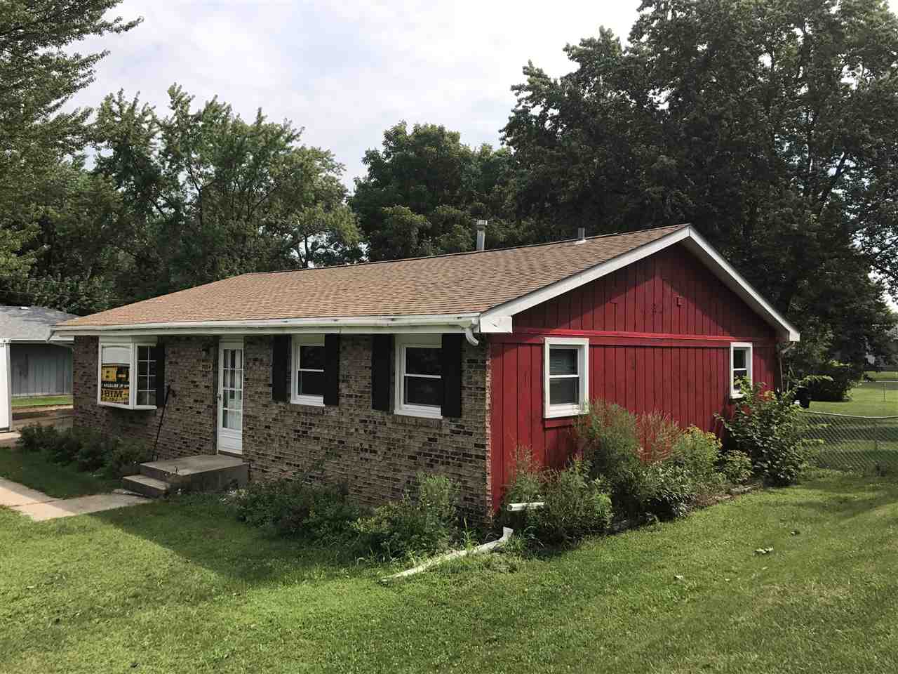 7084 Ralph Road Rockford, IL 61109 - Photo 1 of 21 a view of a yard in front of a house with plants and large tree