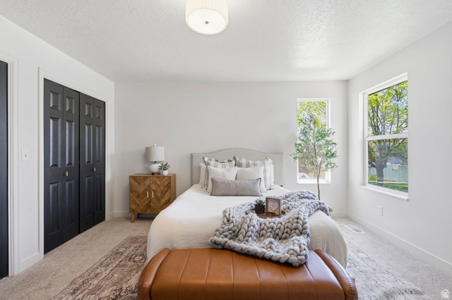 2460 Allison Way Syracuse, UT 84075 - Photo 12 of 24 Bright interior space featuring light-colored walls, carpeted flooring, and a flush-mount ceiling light