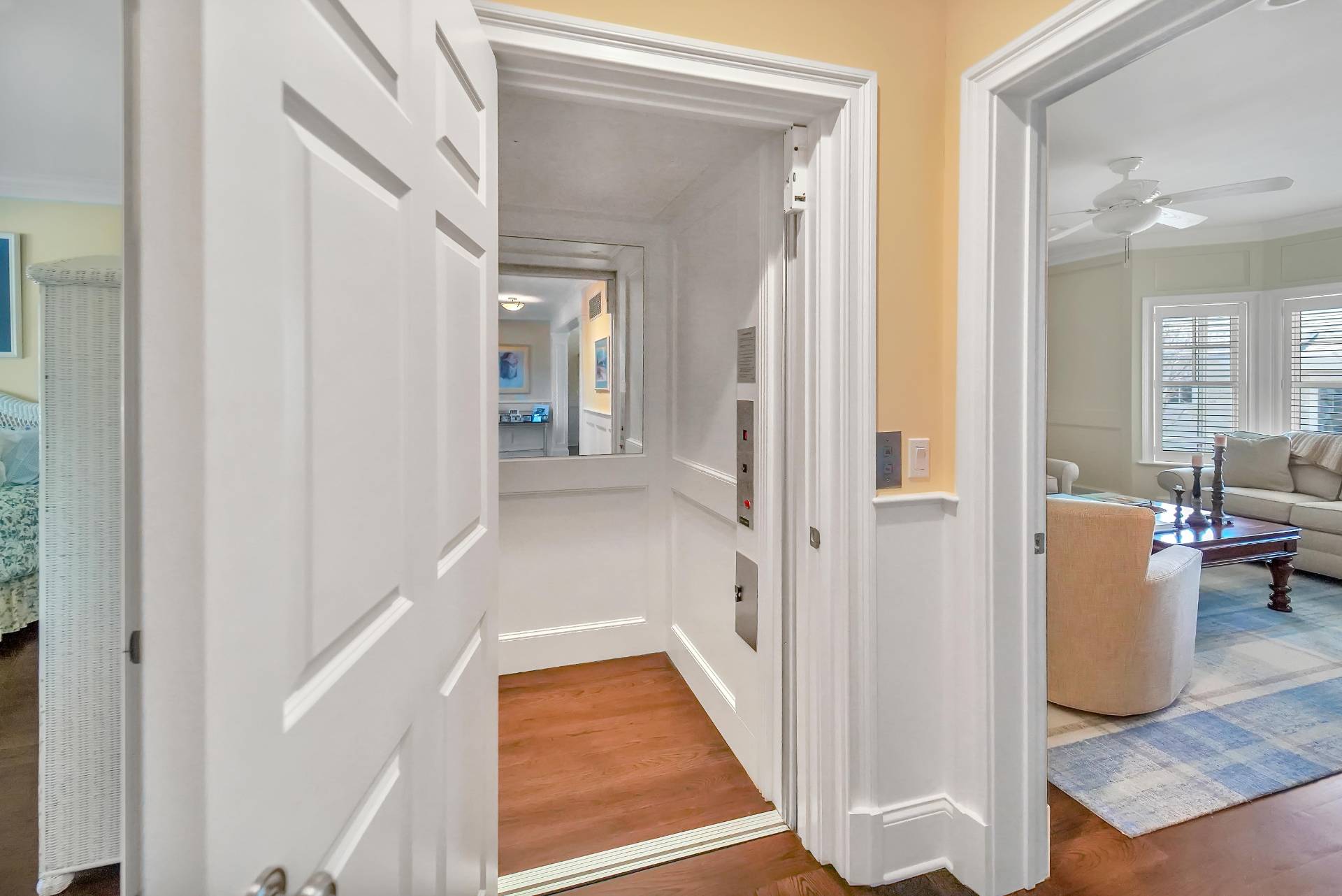 28 Bay Road Quogue, NY 11959 - Photo 15 of 35 a view of a hallway with wooden floor and living room