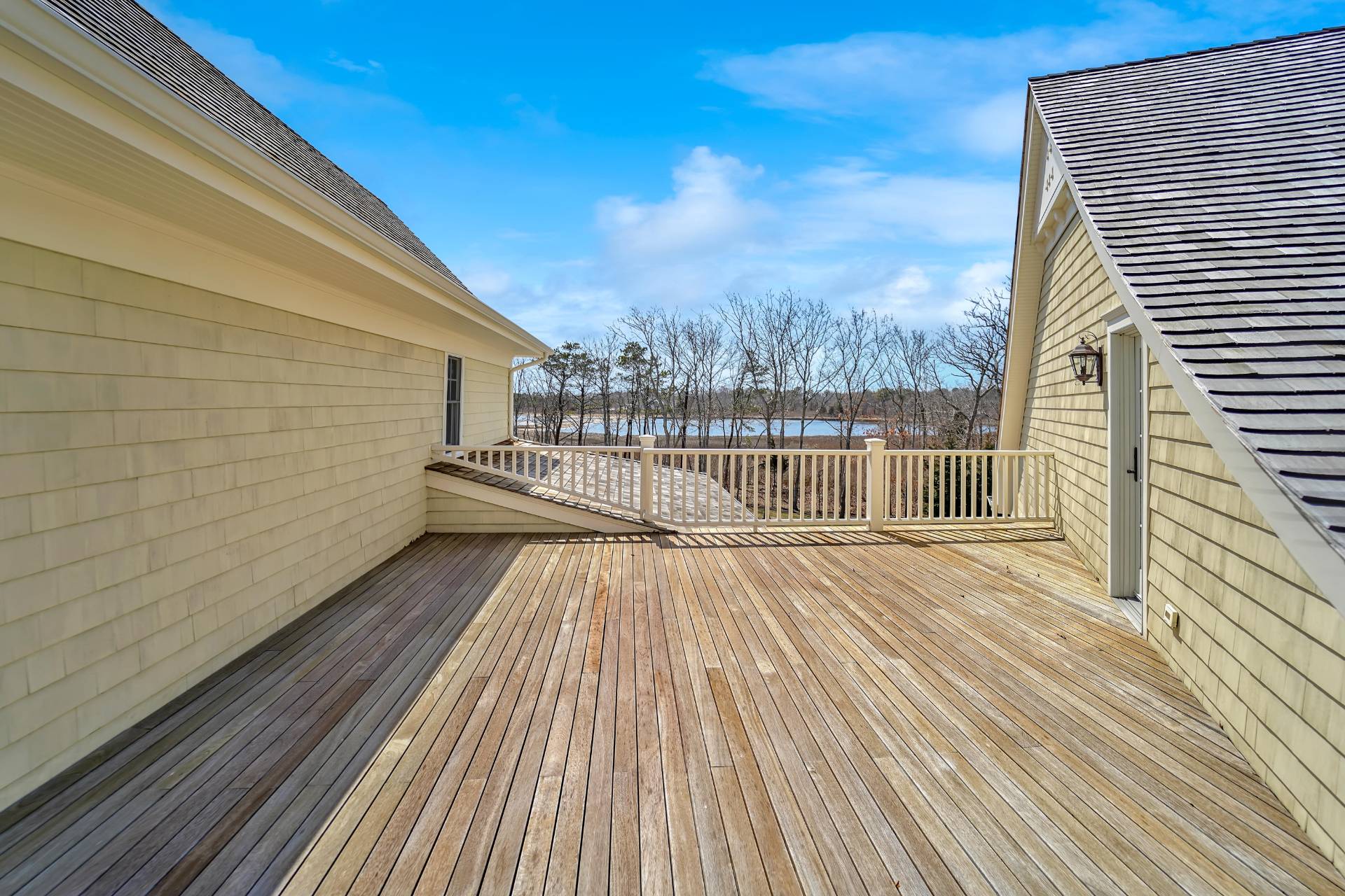 28 Bay Road Quogue, NY 11959 - Photo 21 of 35 a view of a balcony with wooden floor and city view
