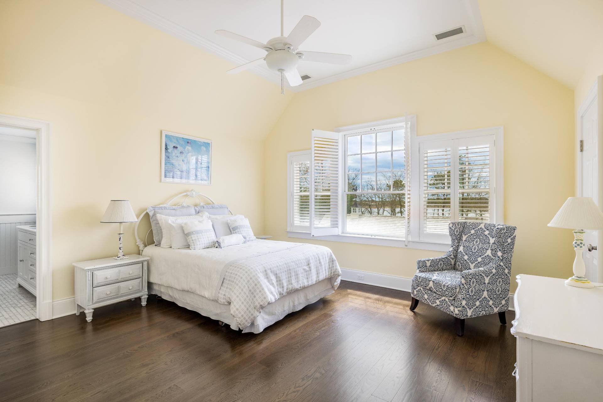 28 Bay Road Quogue, NY 11959 - Photo 22 of 35 a bedroom with a bed couch and a large window with wooden floor