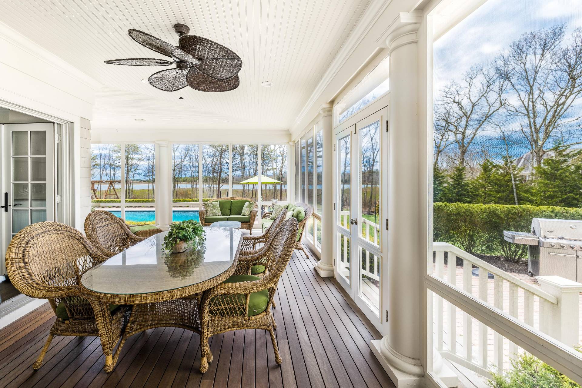 28 Bay Road Quogue, NY 11959 - Photo 29 of 35 a view of a balcony dining table and chairs with a floor to ceiling window