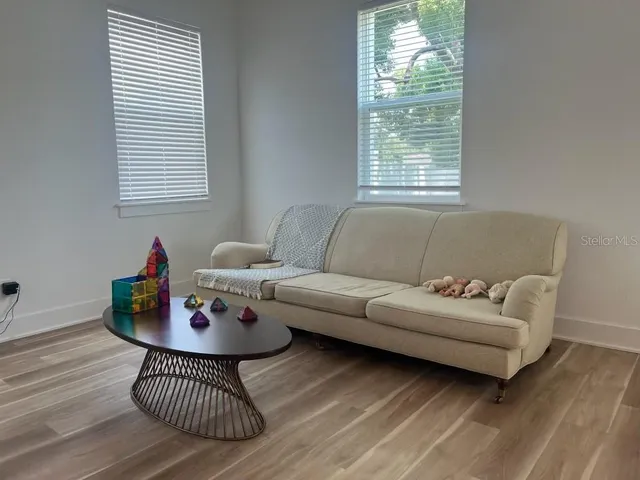 a living room with furniture and a window