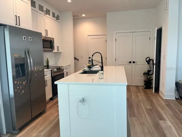 a kitchen with a refrigerator and a sink