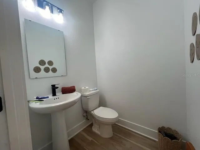 a bathroom with a toilet sink and mirror