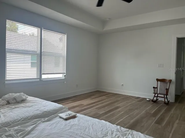 a bed sitting in a bedroom next to a window