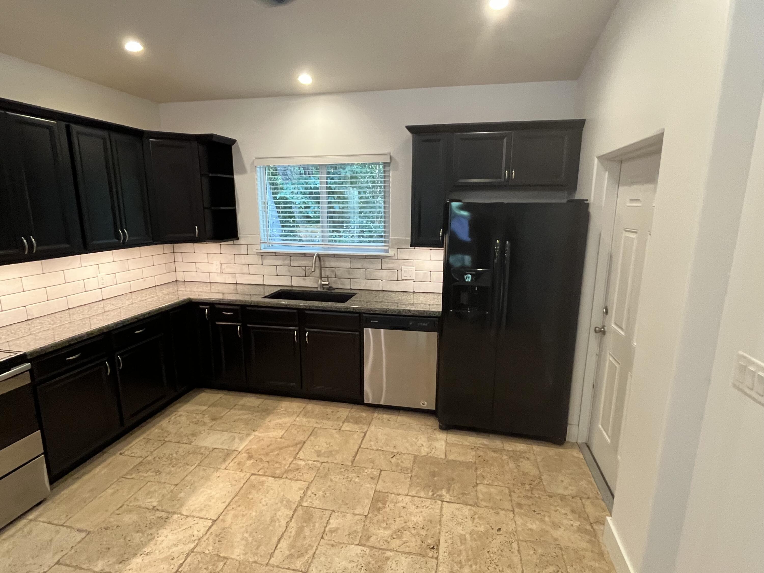 639 Cabrera Street Key Largo, FL 33037 - Photo 11 of 24 a kitchen with a sink and a stove