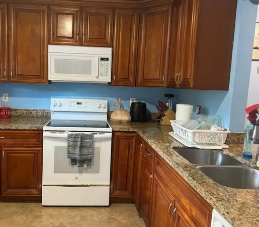a kitchen with granite countertop cabinets and steel stainless steel appliances