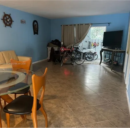 a view of a livingroom with furniture and a flat screen tv