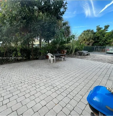 a view of a backyard with sitting area