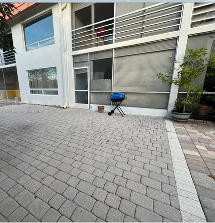 a view of a brick house with a yard