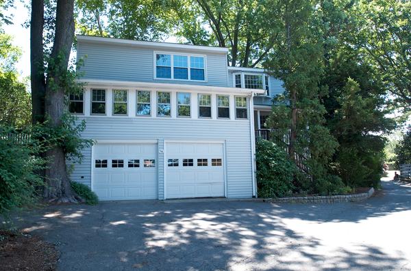 16 Neptune Road Marblehead, MA 01945 - Photo 1 of 22 a view of a large building with large windows and a large tree