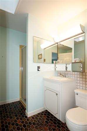 16 Neptune Road Marblehead, MA 01945 - Photo 17 of 22 a bathroom with a sink a toilet a mirror and vanity