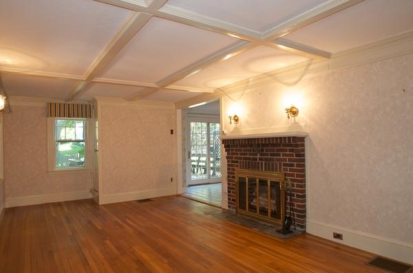 16 Neptune Road Marblehead, MA 01945 - Photo 4 of 22 a living room with a fireplace and wooden floor
