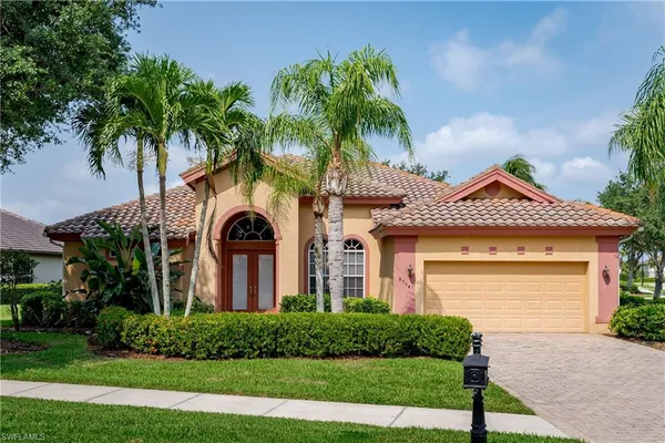 a front view of a house with a garden and plants