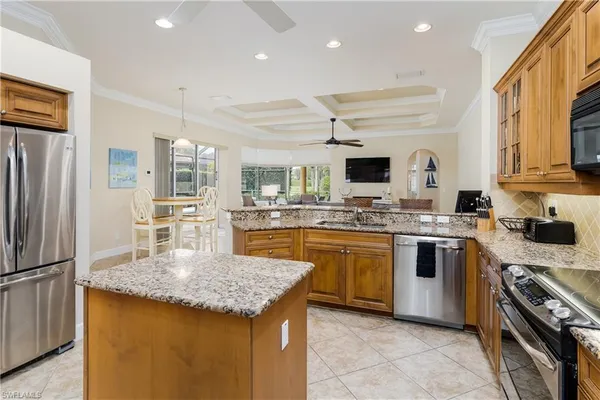 a kitchen with stainless steel appliances granite countertop a sink stove and refrigerator