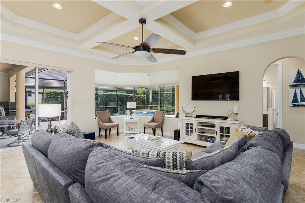 8754 Hideaway Harbor Court Naples, FL 34120 - Photo 18 of 49 a living room with furniture and a flat screen tv