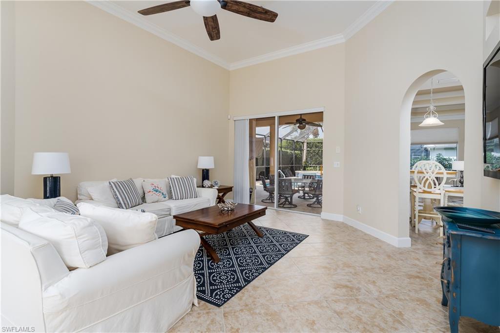 8754 Hideaway Harbor Court Naples, FL 34120 - Photo 19 of 49 a living room with furniture and a chandelier