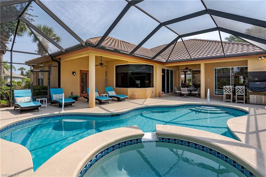 8754 Hideaway Harbor Court Naples, FL 34120 - Photo 2 of 49 a view of a house with a swimming pool