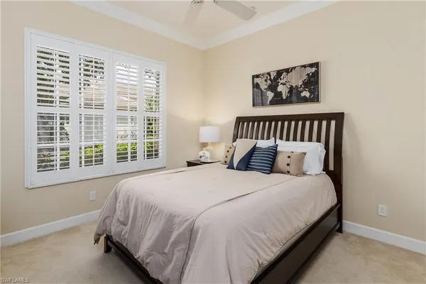a large bed sitting in a bedroom next to a window
