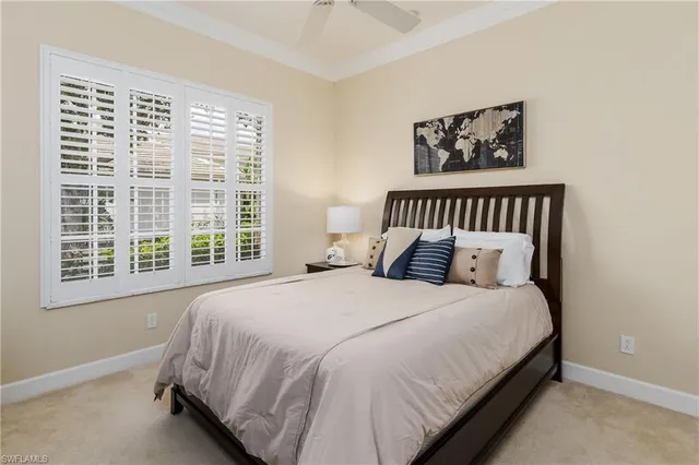 a large bed sitting in a bedroom next to a window