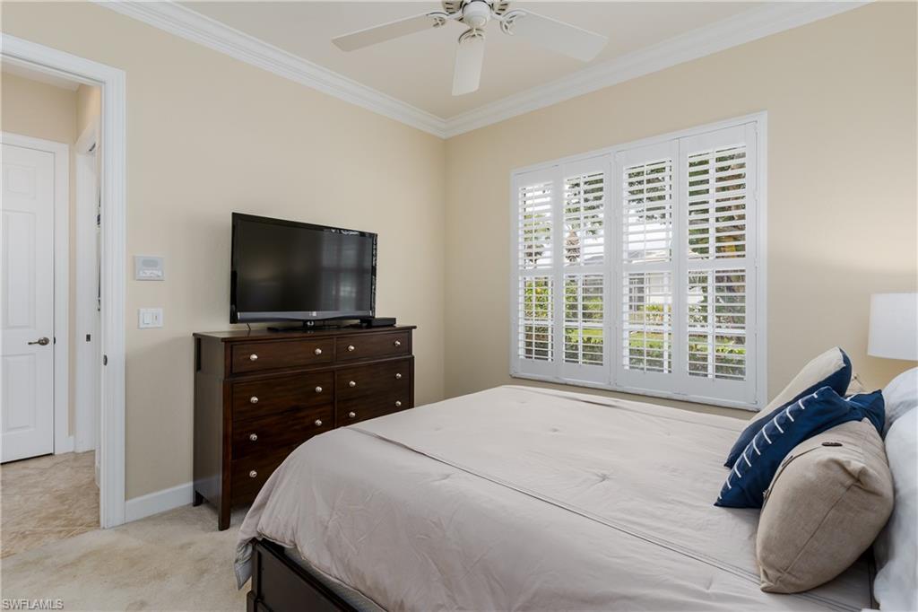 8754 Hideaway Harbor Court Naples, FL 34120 - Photo 28 of 49 a bedroom with a bed and a flat screen tv