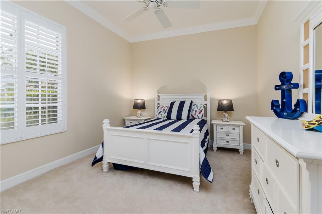 8754 Hideaway Harbor Court Naples, FL 34120 - Photo 29 of 49 a white bed sitting in a bedroom next to a window