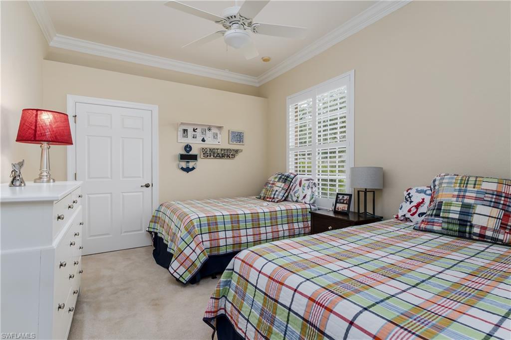 8754 Hideaway Harbor Court Naples, FL 34120 - Photo 30 of 49 a bedroom with two beds and a window