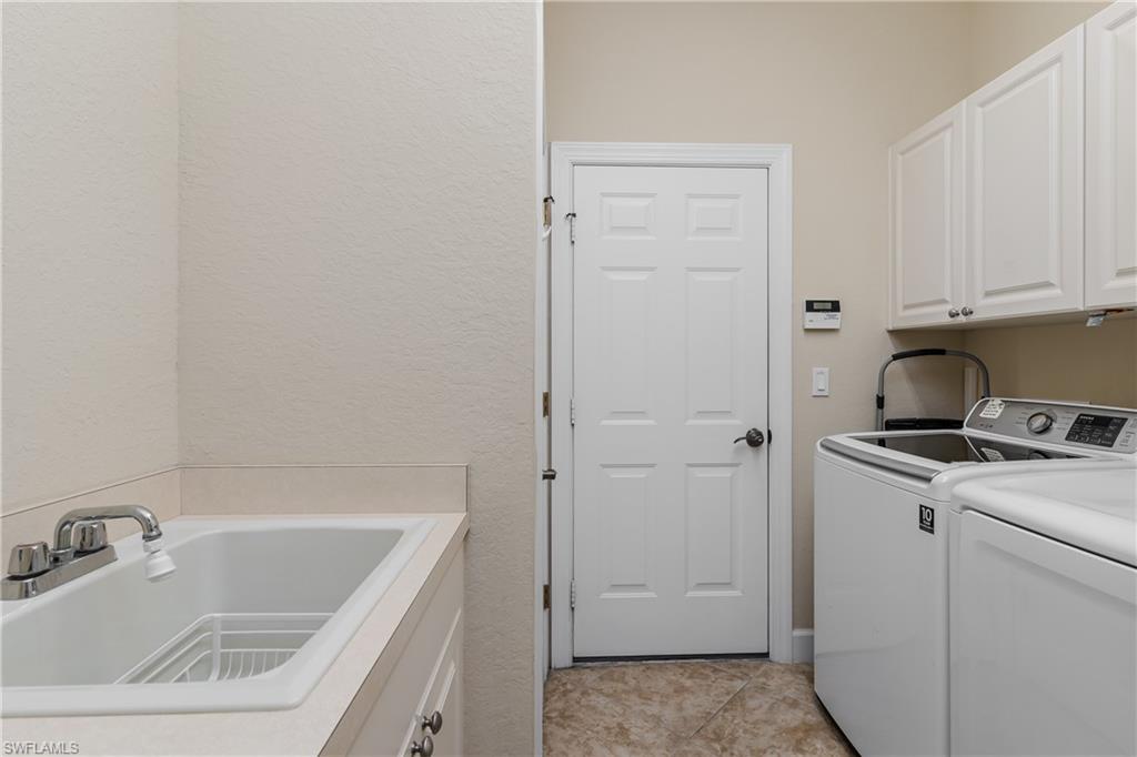 8754 Hideaway Harbor Court Naples, FL 34120 - Photo 32 of 49 a bathroom with a sink a vanity and tub