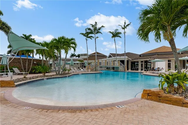 a view of a house with pool and chairs