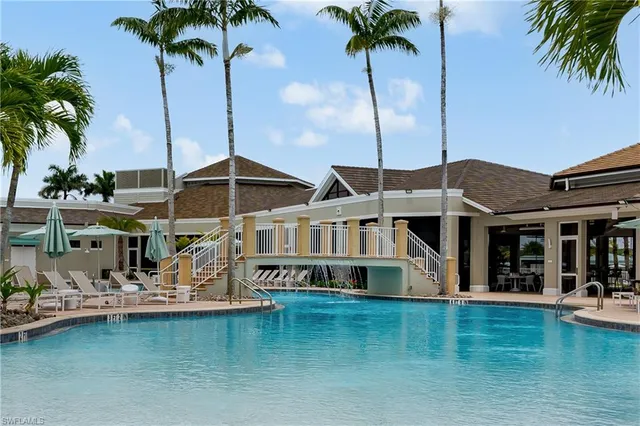 a front view of a house with swimming pool and porch