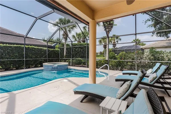 a view of a patio with a table chairs and a backyard