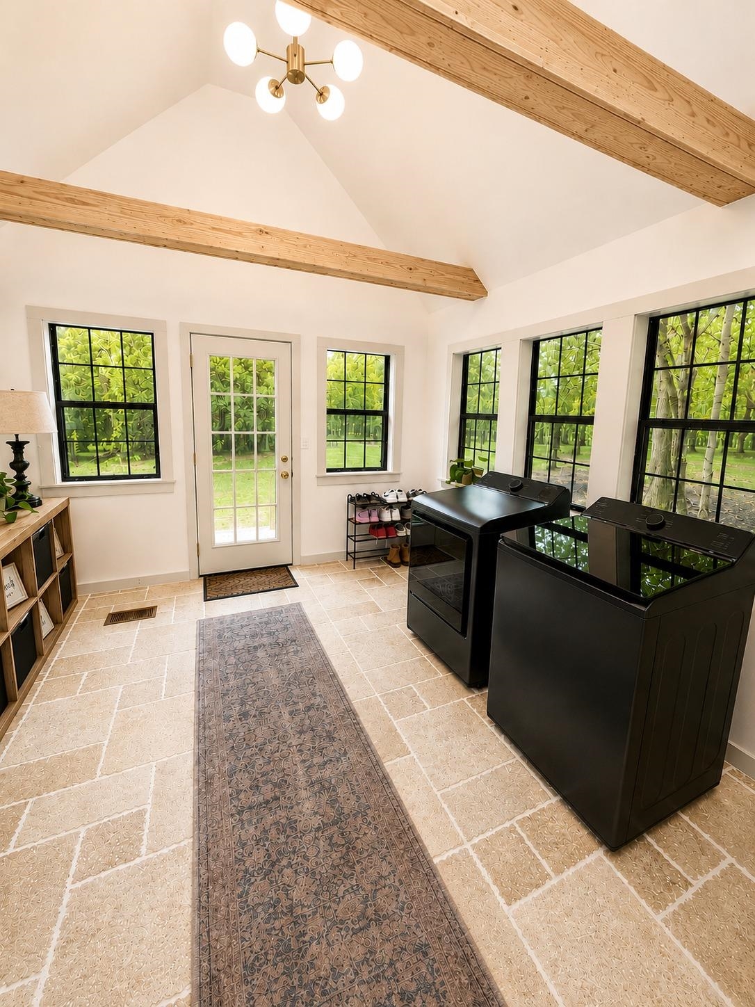470 Rich Road Somerville, TN 38068 - Photo 14 of 40 Spacious utility room featuring a vaulted ceiling with exposed wood beams, a contemporary chandelier, and large-pane windows