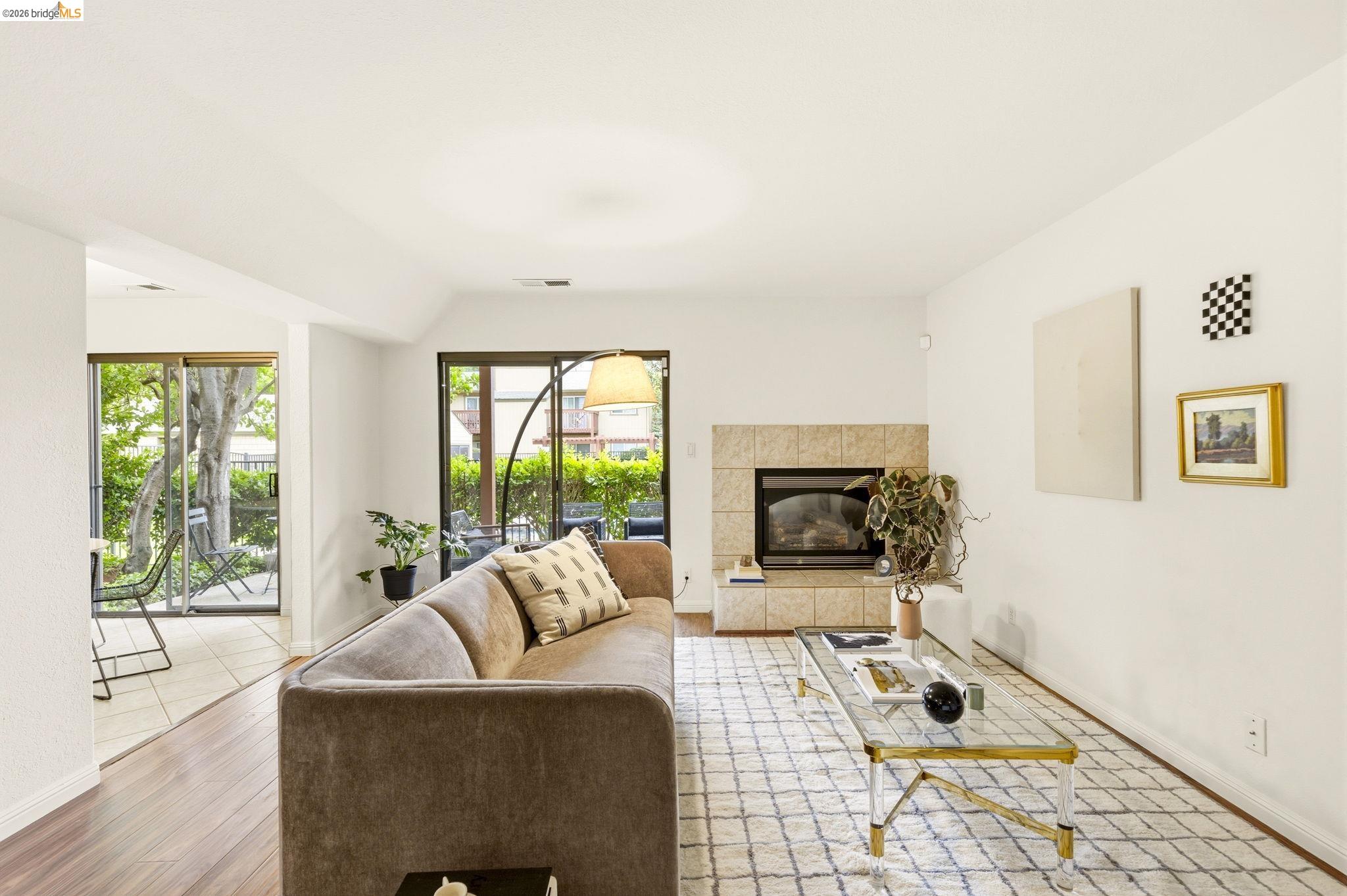 20111 West Ridge Court, Unit 13 Castro Valley, CA 94546 - Photo 2 of 50 Living area featuring light wood-type flooring and a fireplace