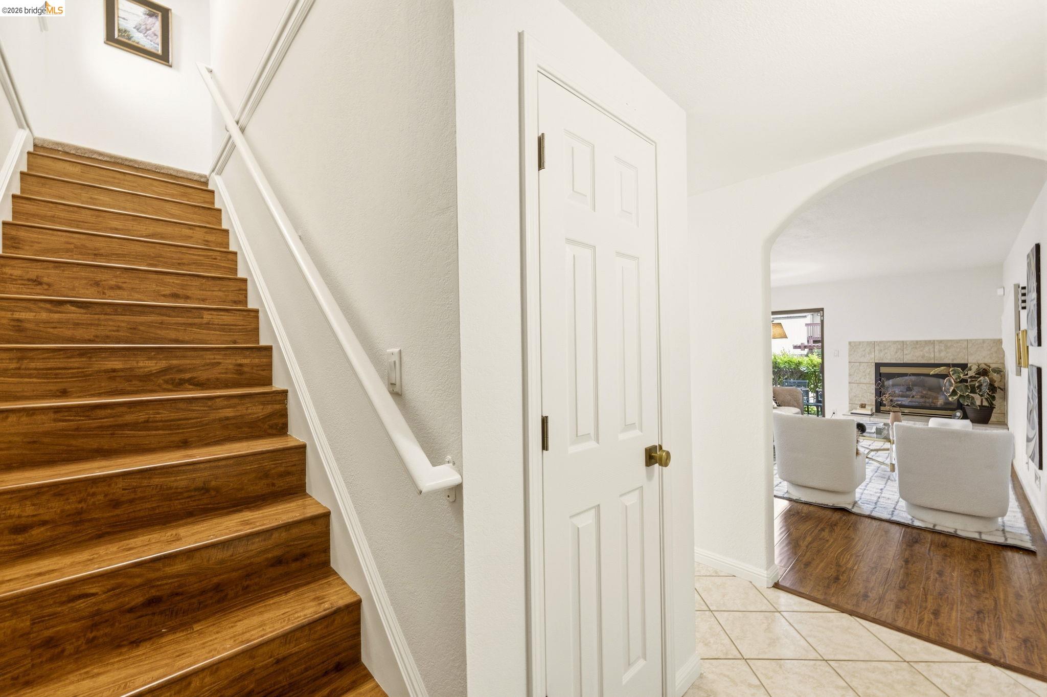 20111 West Ridge Court, Unit 13 Castro Valley, CA 94546 - Photo 22 of 50 Staircase with tile patterned flooring, arched walkways, and a tile fireplace
