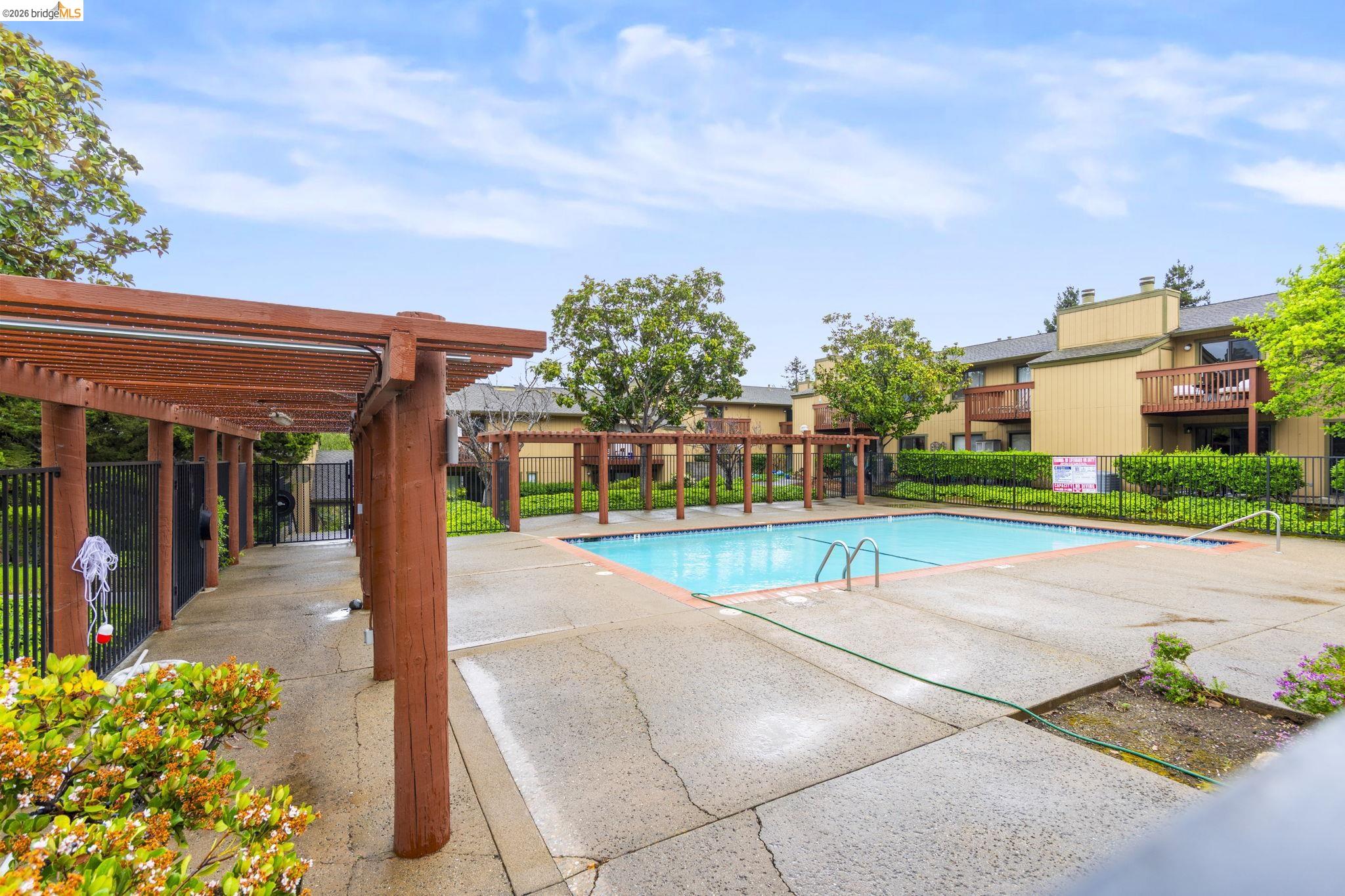 20111 West Ridge Court, Unit 13 Castro Valley, CA 94546 - Photo 42 of 50 Community pool with a pergola and a patio area