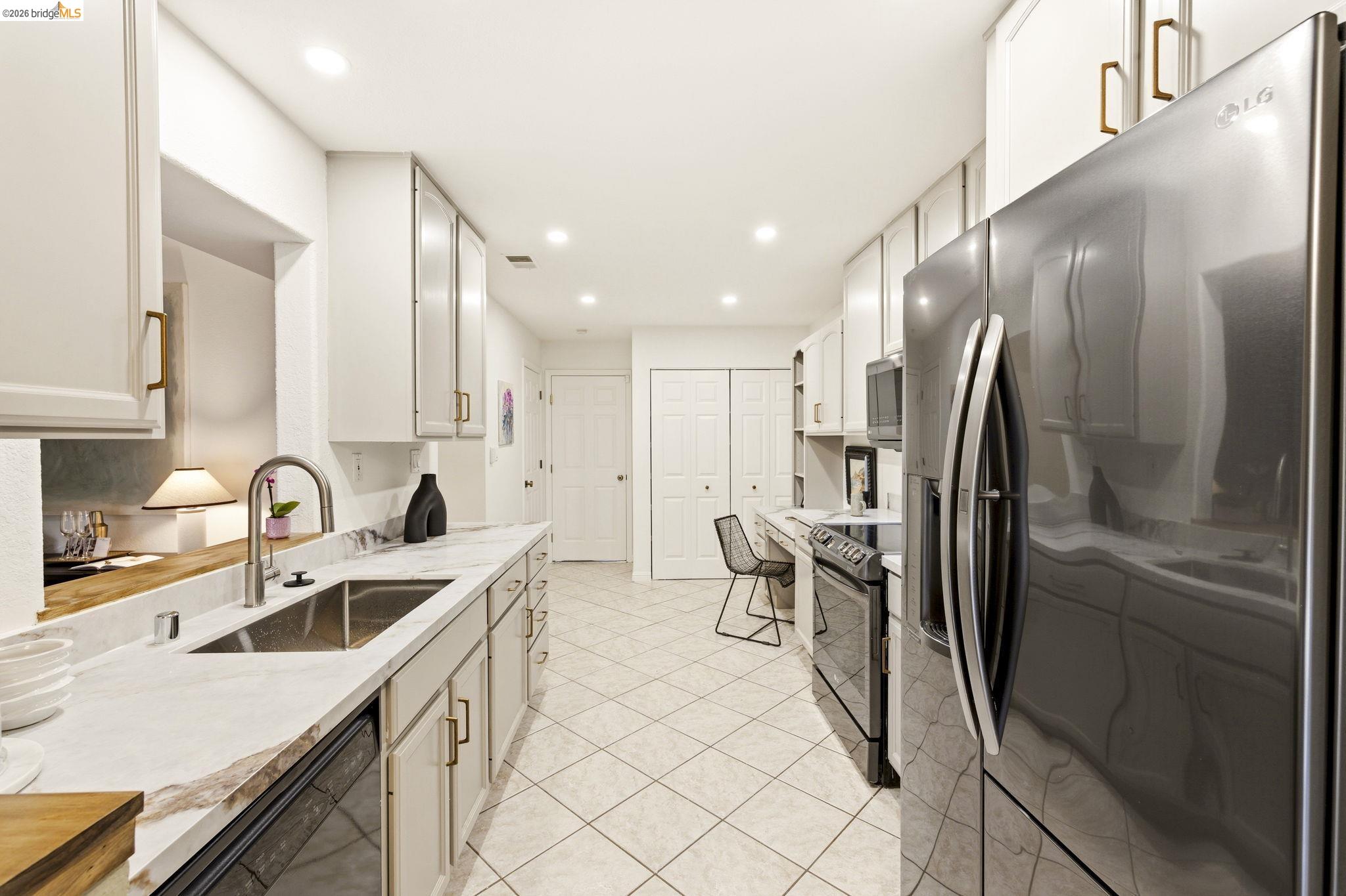 20111 West Ridge Court, Unit 13 Castro Valley, CA 94546 - Photo 8 of 50 Kitchen featuring stainless steel appliances, white cabinetry, recessed lighting, and light tile patterned floors