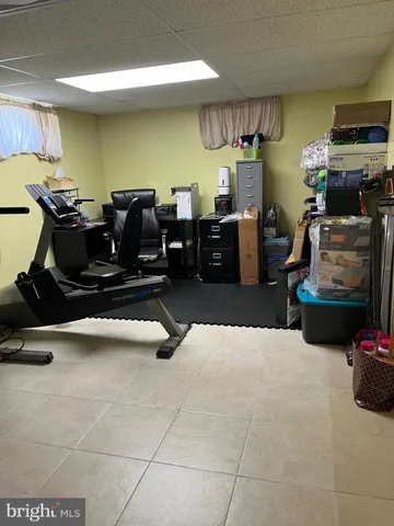 a room with gym equipment and a view of living room