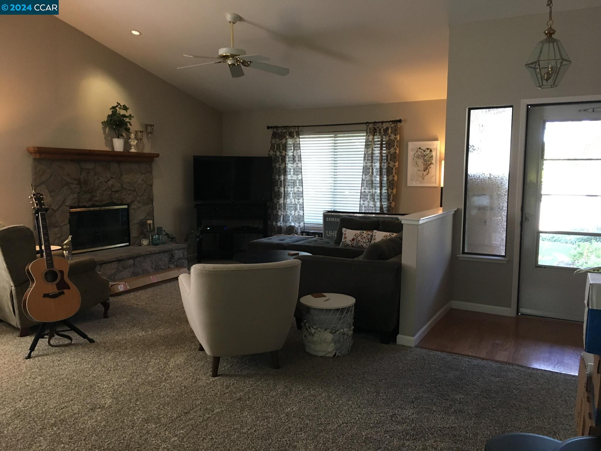 1317 David Lane Concord, CA 94518 - Photo 4 of 16 a living room with furniture a fireplace and a flat screen tv