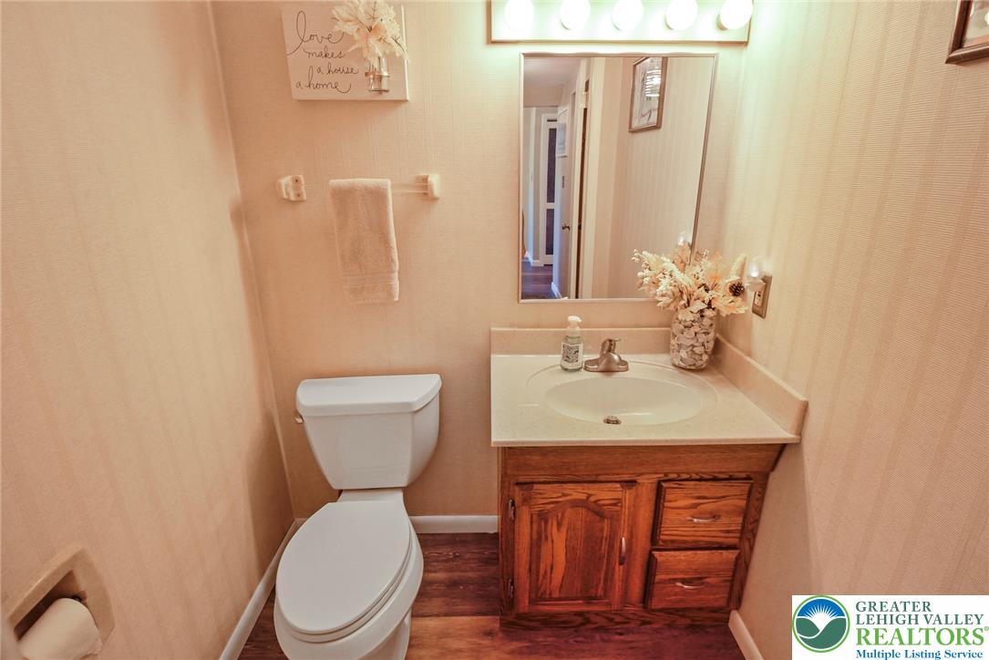 3470 Brodhead Road Bethlehem, PA 18020 - Photo 49 of 84 A compact powder room featuring a wooden vanity and bright overhead lighting.