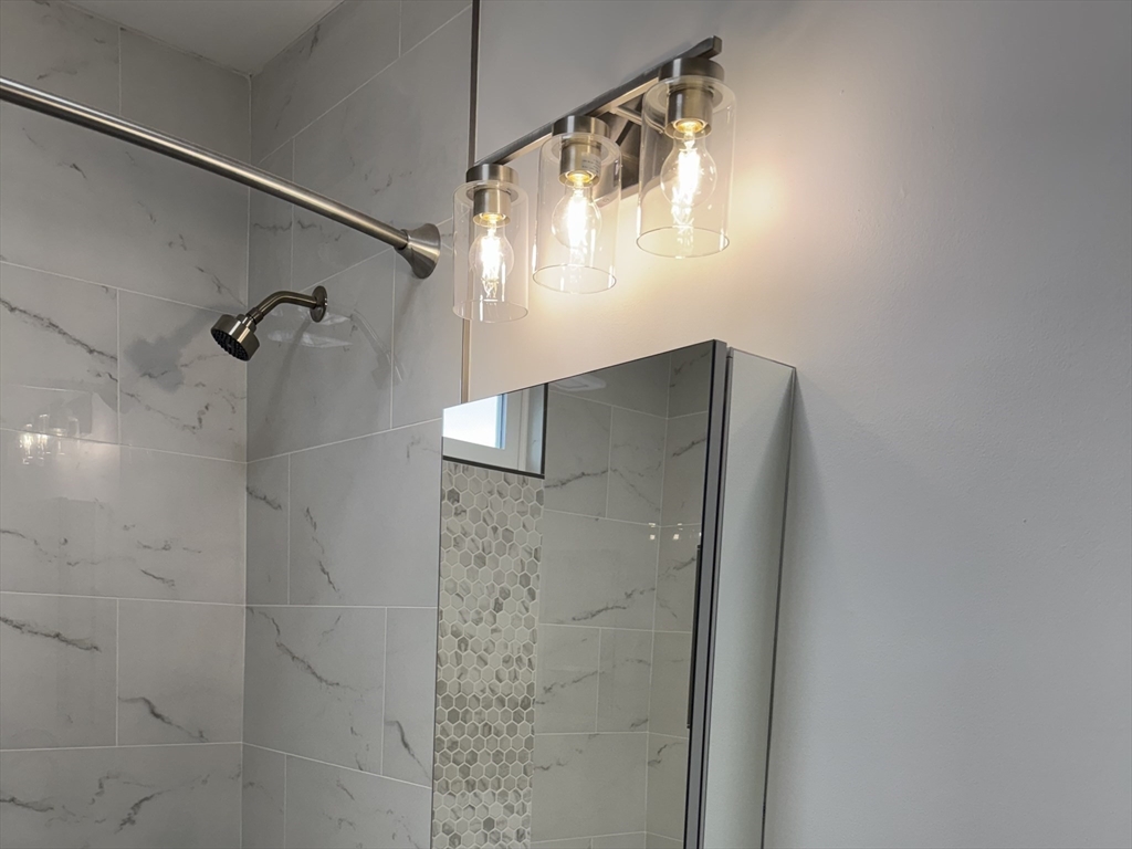 630 Metropolitan Avenue, Unit 3 Boston, MA 02136 - Photo 13 of 31 a bathroom with a shower and a glass door shower