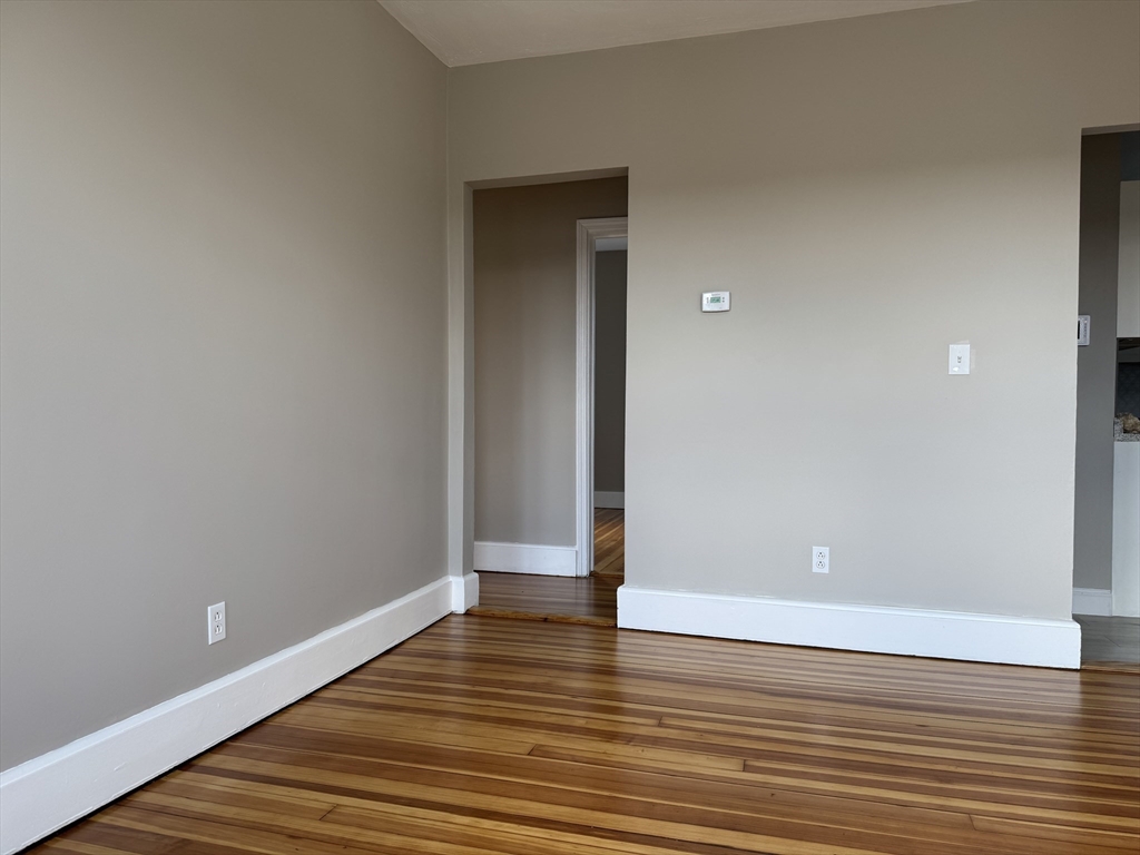 630 Metropolitan Avenue, Unit 3 Boston, MA 02136 - Photo 17 of 31 a view of an empty room with wooden floor and closet