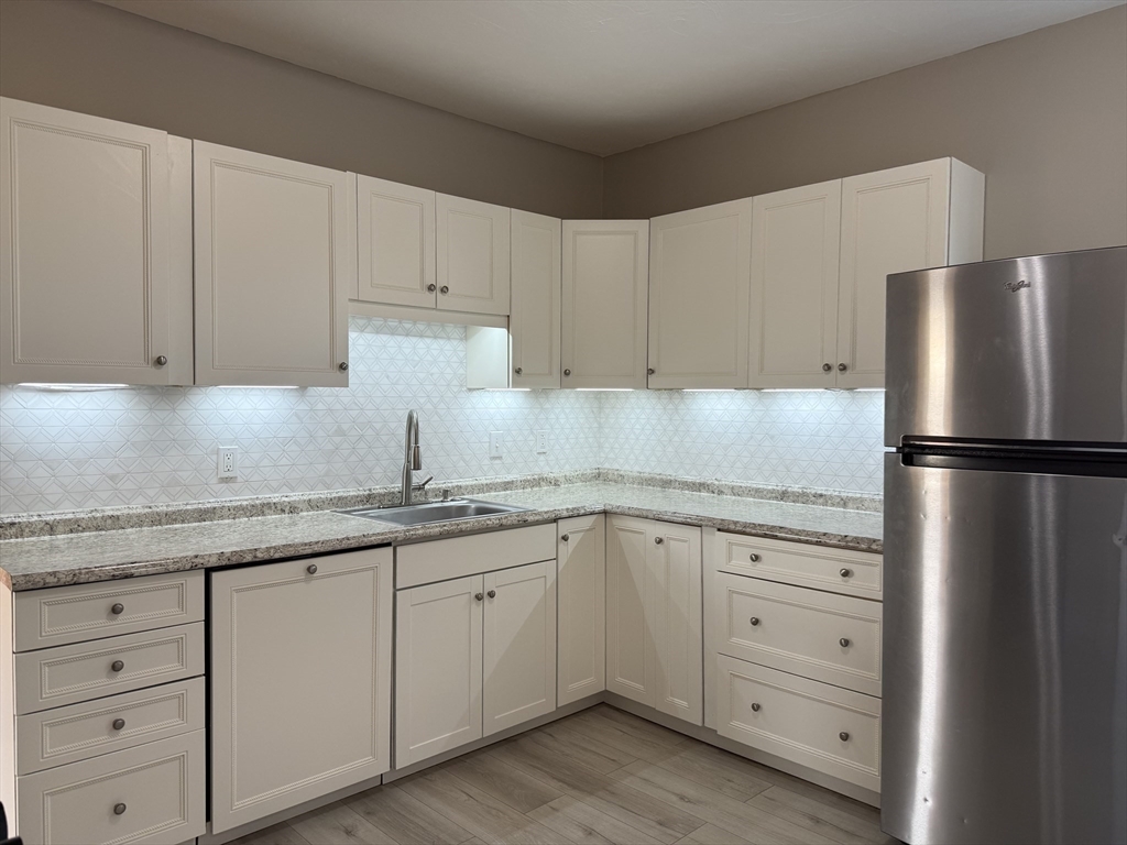 630 Metropolitan Avenue, Unit 3 Boston, MA 02136 - Photo 2 of 31 a kitchen with appliances a sink and cabinets